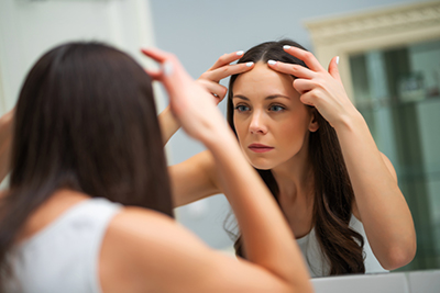 Worried,Woman,Is,Looking,At,Her,Wrinkles,In,The,Bathroom.