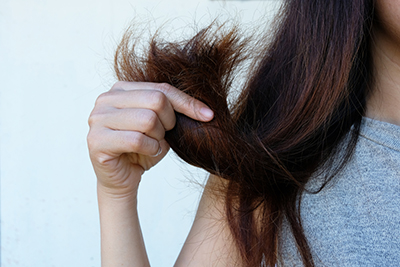 Sad,Young,Woman,With,Long,Hair,In,Hand,,hair,Damage,