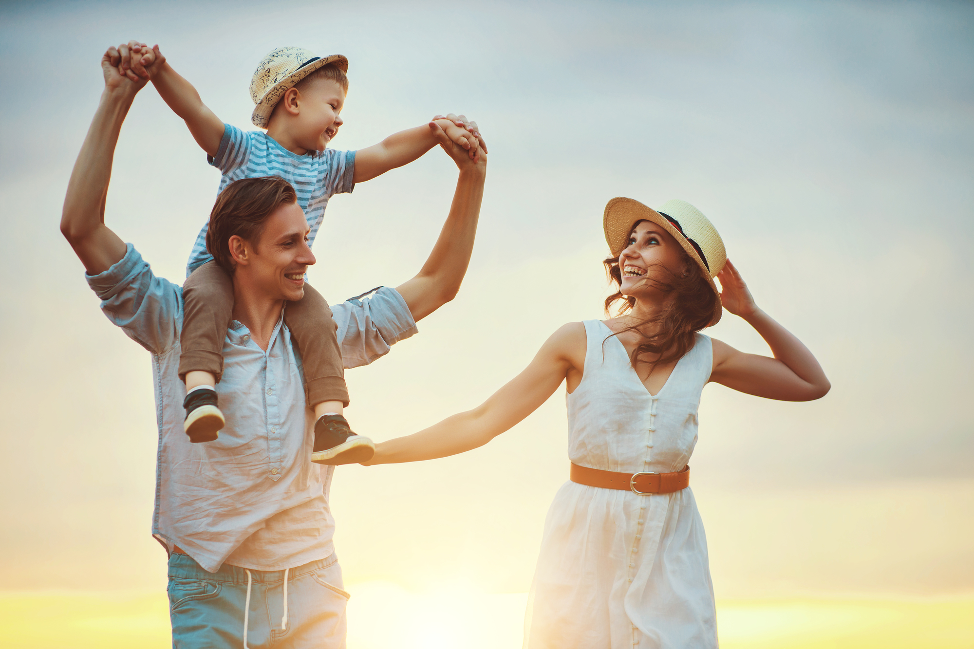 Happy family father of mother and child son  on nature at sunset